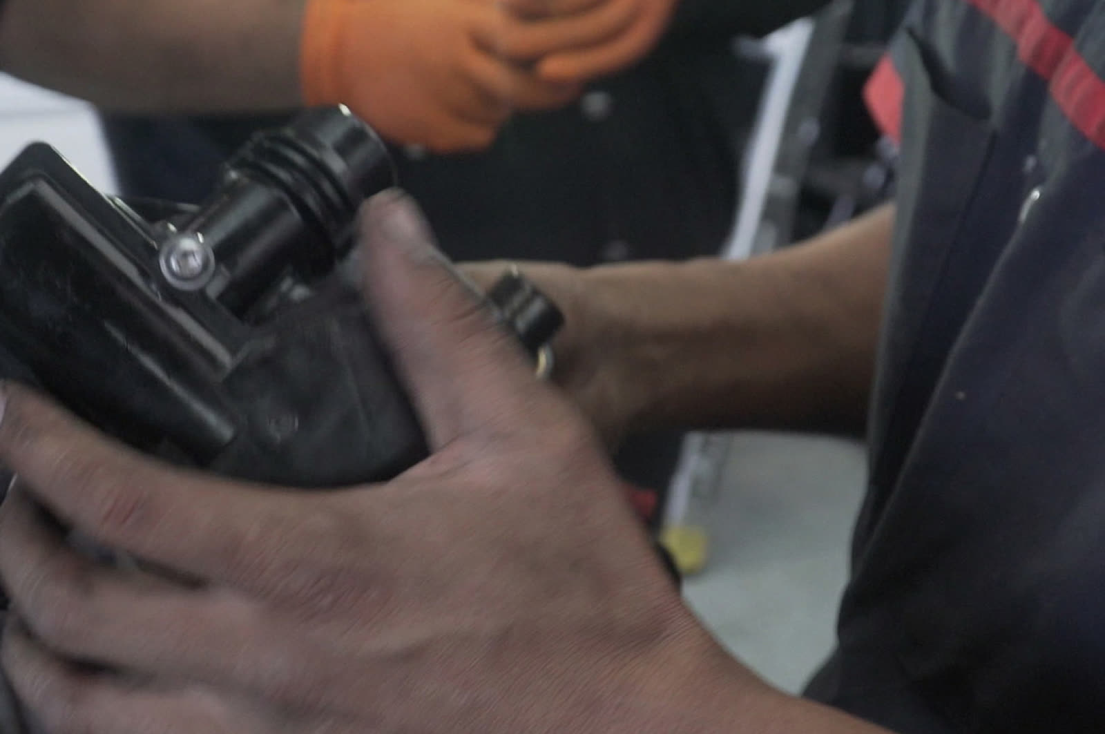 Bay Motors technician closely inspecting an engine part during diagnostics