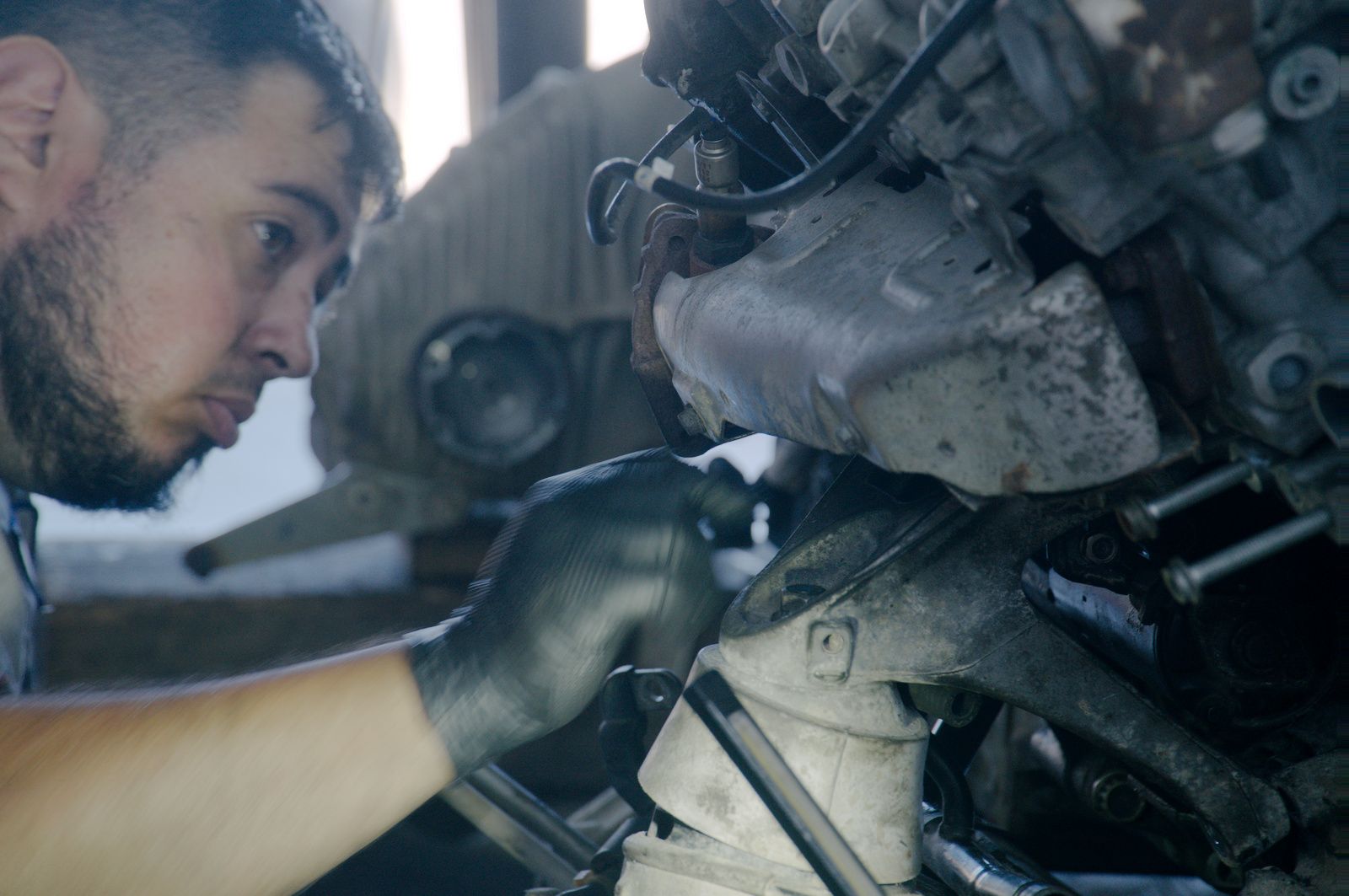 Bay Motors technician diagnosing a vehicle up close