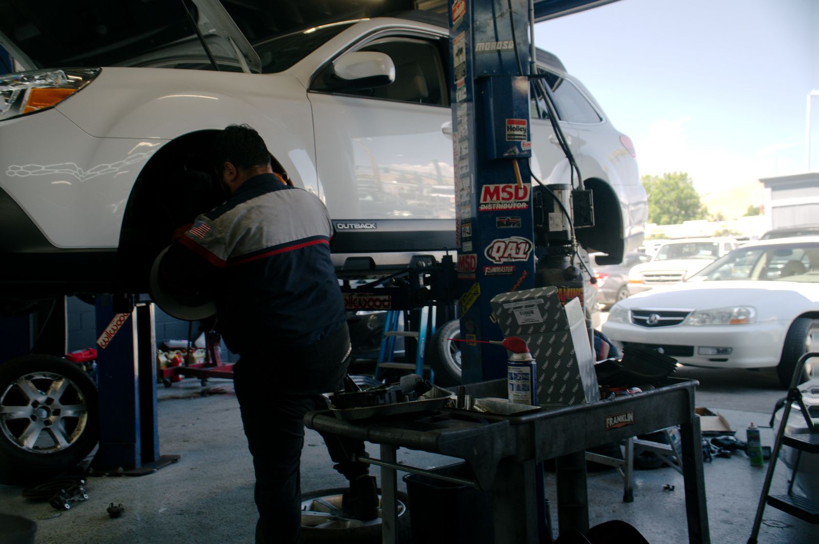 A vehicle up on the lift inside the Bay Motors shop in Hayward