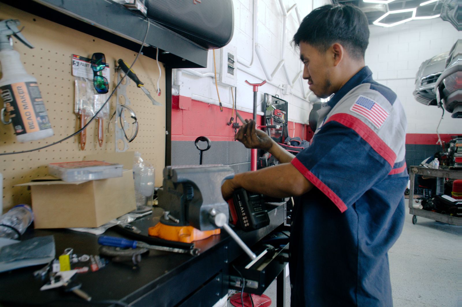 Bay Motors technician at an organized workbench in the shop