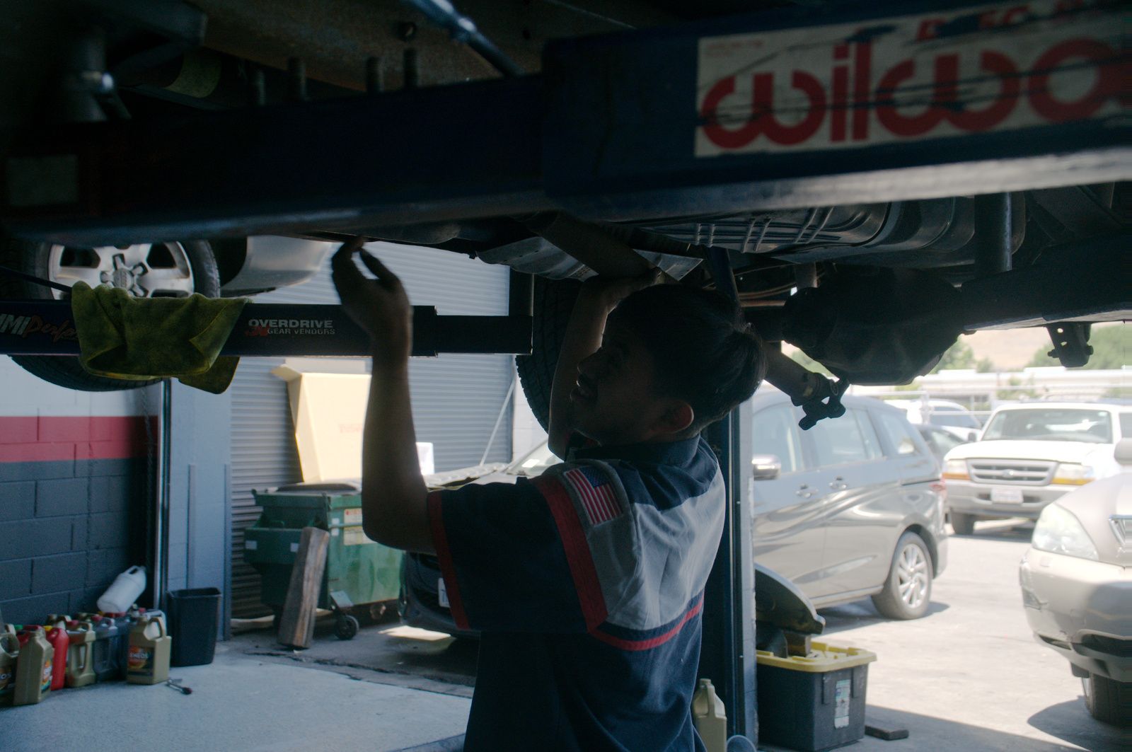 Bay Motors technician working under a vehicle on the lift